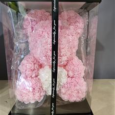 pink bear made out of artificial roses 